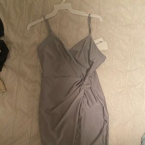 A dance dress that has never been worn before. The tags are still on it.